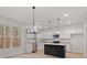 Modern kitchen featuring white cabinets, granite countertops, and a dark kitchen island at 5086 Cumberland Ct, Villa Rica, GA 30180