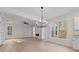 Bright living room featuring a modern chandelier, fireplace, and large windows at 5086 Cumberland Ct, Villa Rica, GA 30180
