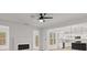Modern living room open to a kitchen with a fireplace and natural light from multiple windows at 5086 Cumberland Ct, Villa Rica, GA 30180