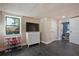 Finished basement with whitewashed wood walls, slate tile floor, and ample storage at 6255 Lakeview Dr, Buford, GA 30518