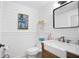 Charming half-bath with shiplap walls, marble-top vanity, and decorative sunflower art at 6255 Lakeview Dr, Buford, GA 30518