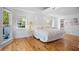 Bright, airy bedroom with wood floors, large windows, and a view of outdoor greenery at 6255 Lakeview Dr, Buford, GA 30518