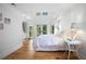 Bright bedroom with wood floors, high ceilings, and French doors leading to outdoor scenery at 6255 Lakeview Dr, Buford, GA 30518