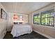Cozy bedroom with a niche headboard and wooded views from the window at 6255 Lakeview Dr, Buford, GA 30518