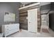 Charming bedroom with a rustic accent wall and a view into the en suite bathroom at 6255 Lakeview Dr, Buford, GA 30518