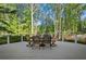 Outdoor dining on large deck with surrounding foliage and wooden railing at 6255 Lakeview Dr, Buford, GA 30518