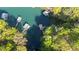 Aerial view of neighborhood docks along tree-lined lake shore offers tranquil waterfront living at 6255 Lakeview Dr, Buford, GA 30518