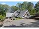 A-frame house with a gravel driveway and lush landscaping at 6255 Lakeview Dr, Buford, GA 30518