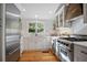 Modern kitchen with stainless steel appliances, wooden accents and white cabinetry at 6255 Lakeview Dr, Buford, GA 30518