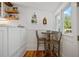 Cozy eat-in kitchen area with white cabinetry, a table, and a window view at 6255 Lakeview Dr, Buford, GA 30518