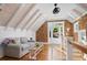 Cozy living room with shingle and white shiplap wall, vaulted ceilings, and wood floors at 6255 Lakeview Dr, Buford, GA 30518