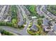 Overhead view of neighborhood showcasing a home with lush trees and the community pool at 11210 Easthaven Pl, Duluth, GA 30097