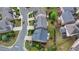 Birds-eye view of a neighborhood street highlighting a home with manicured landscaping and a blue roof at 11210 Easthaven Pl, Duluth, GA 30097