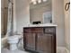 Bathroom showcasing a vanity with a sink and a mirror, alongside a toilet and a bathtub with a shower curtain at 11210 Easthaven Pl, Duluth, GA 30097