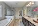 Beautiful bathroom featuring double sinks, granite countertops, a soaking tub, and walk-in shower at 11210 Easthaven Pl, Duluth, GA 30097