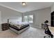 Neutral bedroom featuring gray walls, plush carpet, large window and desk area at 11210 Easthaven Pl, Duluth, GA 30097