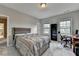 Neutral bedroom features a comfortable bed, a black bookcase and a desk, for a modern touch at 11210 Easthaven Pl, Duluth, GA 30097
