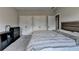 This bedroom has a large comfortable bed, two double closets, and a modern black dresser for ample storage at 11210 Easthaven Pl, Duluth, GA 30097