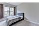 Cozy bedroom with a comfortable bed, soft carpet, and a large window providing natural light at 11210 Easthaven Pl, Duluth, GA 30097
