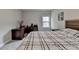 Neutral bedroom featuring gray walls, plush carpet, large window, and desk area at 11210 Easthaven Pl, Duluth, GA 30097