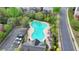 An aerial shot features the community pool surrounded by greenery and lounge seating at 11210 Easthaven Pl, Duluth, GA 30097