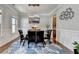 Stylish dining room featuring a glass table, wainscoting and a modern chandelier at 11210 Easthaven Pl, Duluth, GA 30097