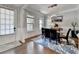 Well-lit dining room with hardwood floors, modern chandelier, and stylish furnishings at 11210 Easthaven Pl, Duluth, GA 30097