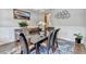Formal dining area with a glass top table, seating for six, and decorative wall art at 11210 Easthaven Pl, Duluth, GA 30097