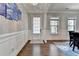 Elegant entryway featuring hardwood floors, wainscoting, and stylish decor at 11210 Easthaven Pl, Duluth, GA 30097