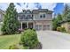 Charming two-story home with a brick and gray shingle exterior and a two-car garage at 11210 Easthaven Pl, Duluth, GA 30097