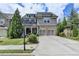 Beautiful two-story home with a brick and gray shingle exterior and a two-car garage at 11210 Easthaven Pl, Duluth, GA 30097