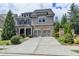 Beautiful two-story home with a brick and gray shingle exterior and a two-car garage at 11210 Easthaven Pl, Duluth, GA 30097