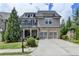 Beautiful two-story home with a brick and gray shingle exterior and a two-car garage at 11210 Easthaven Pl, Duluth, GA 30097