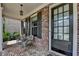 Comfortable front porch with seating area and elegant glass paneled front door at 11210 Easthaven Pl, Duluth, GA 30097