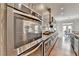 Kitchen has stainless double oven and gray wood cabinets, plus granite countertops and hardwood floors at 11210 Easthaven Pl, Duluth, GA 30097