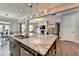 Open kitchen has a large island with stainless appliances, granite countertops and hardwood floors at 11210 Easthaven Pl, Duluth, GA 30097