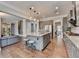 Open-concept kitchen with a large island, gray cabinetry, stainless appliances, and hardwood floors extending to the living area at 11210 Easthaven Pl, Duluth, GA 30097