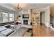 Cozy living room featuring hardwood floors, modern decor, and a fireplace at 11210 Easthaven Pl, Duluth, GA 30097