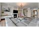 Open concept living area with a fireplace, stylish decor, and hardwood floors at 11210 Easthaven Pl, Duluth, GA 30097