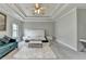 Spacious main bedroom suite with a tray ceiling, plush carpet, and ample seating, creating a relaxing retreat at 11210 Easthaven Pl, Duluth, GA 30097