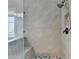 Modern shower with gray tile, a glass enclosure, and rainfall shower head, designed for a spa-like experience at 11210 Easthaven Pl, Duluth, GA 30097