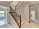 Elegant staircase featuring carpeted steps, and decorative iron spindles offering a seamless transition between floors at 11210 Easthaven Pl, Duluth, GA 30097