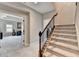 Carpeted stairs with a wood handrail lead to an open living area, creating a seamless transition between floors at 11210 Easthaven Pl, Duluth, GA 30097