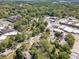Aerial view showcasing a charming small town, with tree-lined streets and commercial buildings, surrounded by lush greenery at 181 W Hightower Trl, Social Circle, GA 30025