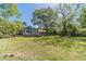 Well-manicured backyard with mature trees, offering a peaceful outdoor space at 181 W Hightower Trl, Social Circle, GA 30025