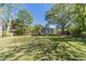 Large backyard with mature trees, providing ample shade and a serene setting at 181 W Hightower Trl, Social Circle, GA 30025