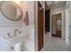 Elegant bathroom with a pedestal sink, vintage faucet, and a view into a tiled shower room at 181 W Hightower Trl, Social Circle, GA 30025