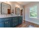 Bright bathroom with double sinks, marble counters, and a large window overlooking the backyard at 181 W Hightower Trl, Social Circle, GA 30025