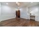 Bright bedroom featuring hardwood floors, a built-in desk, a modern light fixture, and classic trim at 181 W Hightower Trl, Social Circle, GA 30025
