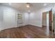 Spacious bedroom with hardwood floors, built-in shelving, classic trim, and a neutral color palette at 181 W Hightower Trl, Social Circle, GA 30025